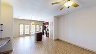 Located at 5437 Bowman Rd in Macon, GA, this well-appointed one-bedroom, one-bathroom unit offers a thoughtfully designed open-concept layout with wood-style flooring throughout. The living area is bright and airy, featuring a ceiling fan and built-in shelving with a granite desk ledge, adding both functionality and style to the space.

The kitchen is a standout feature, showcasing rich dark cabinetry, granite countertops, and a full suite of stainless steel appliances including a side-by-side refrigerator with ice maker, electric range, and microwave. A peninsula with an undermount sink and pendant lighting overhead provides additional prep space and a natural gathering point. French doors allow ample natural light to pour in, connecting the kitchen and living areas to the outside.

The bedroom is a comfortable and well-lit retreat, with a large window fitted with wood-framed blinds offering views of the surrounding landscape. A ceiling fan adds comfort, and the room is served by a dedicated walk-in closet with wire shelving for organized storage.

The bathroom features a granite-topped dark wood vanity with an undermount sink, a large mirror, and a full tub-shower combination with tiled surround, all finished with the same warm wood-style flooring found throughout the unit.