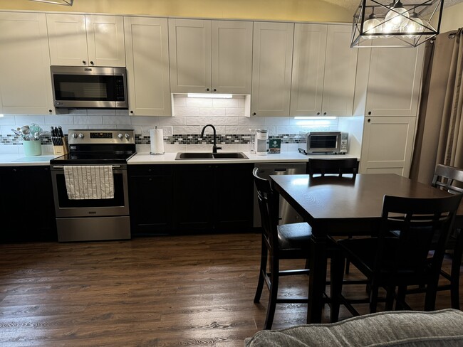 large new kitchen with tons of cabinets fully furnished - 4449 Charles St