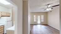 Located at 2900 W Highland St in Chandler, AZ, this single-story home offers four bedrooms and two bathrooms across a well-organized floor plan. The living room is a welcoming, open space featuring wood-look plank flooring, a ceiling fan with light fixture, a textured ceiling, and a glass panel door flanked by windows that invite natural light and provide views of the outdoors. The kitchen is outfitted with light wood cabinetry, white appliances including a range, over-the-range microwave, and refrigerator, along with generous counter space and a double-basin sink. The bedrooms are carpeted for comfort, each with neutral wall tones and windows that allow in natural light; several rooms include ceiling fans. The spacious primary bedroom features a walk-in closet complete with dual hanging rods and built-in shelving for organized storage. Both bathrooms are finished with light wood vanities, white countertops, and shower-tub combinations. Wood-look flooring continues into the bathrooms for a cohesive aesthetic. A hallway connects the private areas of the home, and two closets provide additional storage. The overall ambiance is clean, neutral, and functional, making this a practical and comfortable residence in the heart of Chandler.