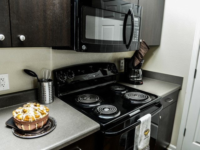 Sleek, black appliances. - Independence Place Prince George
