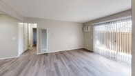 Located at 700 W La Jolla St in Placentia, CA, this single-story, 3-bedroom, 2-bathroom home offers a well-organized layout with consistent, modern finishes throughout. Light wood-style vinyl flooring runs through the main living areas and bedrooms, complementing the neutral warm-gray and beige wall tones that create a cohesive, move-in-ready feel.

The combined kitchen and living room area forms the heart of the home. The kitchen features crisp white shaker-style cabinetry with contemporary bar-pull hardware, granite-look countertops, a stainless steel double sink, and a black gas range with an overhead vent hood. A ceiling fan adds comfort to the open living area, which benefits from a sliding glass door with vertical blinds, inviting natural light and outdoor views.

Three bedrooms offer practical living spaces, each with light flooring, neutral walls, and sliding-door closets providing ample storage. Several bedrooms include large windows with vertical blinds, allowing generous natural light. The primary bedroom includes a full-width double sliding closet.

The two bathrooms are finished with white cabinetry, granite-look countertops, and light flooring. One bathroom includes a dual-mirror vanity and a separate toilet compartment, while the other features a clean, all-white shower/tub enclosure. A central hallway connects all rooms efficiently throughout this compact yet functional home.