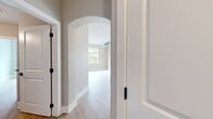 This 1380 square foot apartment in Towson, MD, offers a thoughtful layout with 2 bedrooms and 4 bathrooms. The primary bedroom is generously sized at 180 square feet. The space boasts a modern, open-concept design with a combined kitchen and living area, perfect for entertaining. Light wood flooring runs throughout, complementing the neutral wall tones and creating a bright, airy atmosphere. The kitchen features white cabinetry, stainless steel appliances, and subway tile backsplash. Bathrooms are elegantly appointed with white vanities and tiled showers. Ample storage is provided by multiple closets with wire shelving. A standout feature is the bay window area, offering panoramic views and flooding the space with natural light. The apartment's design emphasizes functionality and style, with clean lines and a contemporary aesthetic evident in every room.