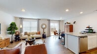This two-floor home offers a thoughtfully designed layout that balances functionality with contemporary style throughout. The main level opens into a bright, open-concept living and dining area finished with light wood-look flooring and recessed lighting. Large windows and a sliding glass door flood the space with natural light while providing access to an outdoor area. The kitchen is well-equipped with white shaker cabinetry, granite countertops, stainless steel appliances, and a central island with a sink — ideal for both everyday cooking and entertaining. A convenient half bath with wood-look flooring completes the main level.

Upstairs, the primary bedroom is a serene retreat featuring a ceiling fan, warm wood flooring, and stylish wall-mounted sconce lighting. A secondary bedroom is characterized by its bold, large-scale world map wall mural, adding a distinctive and creative touch. A versatile additional room serves as a dedicated home office or flex space, complete with natural light from a window and wood flooring. The full bathroom upstairs features tile flooring, a soaking tub with shower, and clean white finishes. Throughout the home, a consistent modern-casual aesthetic ties each space together cohesively.
