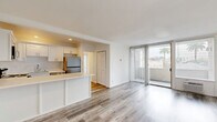 Located at 1840 Winona Blvd in the desirable Los Feliz neighborhood of Los Angeles, this one-bedroom, one-bathroom residence offers a well-designed layout with modern finishes throughout. Light wood-style flooring runs continuously across the entire unit, creating a clean, cohesive aesthetic.

The open-concept living and kitchen area serves as the heart of the home. The kitchen is outfitted with white shaker cabinetry, a subway tile backsplash, quartz countertops, a breakfast bar peninsula, and a full suite of stainless steel appliances including a refrigerator, electric range, microwave, and dishwasher. The living area flows naturally toward a wall of floor-to-ceiling sliding glass doors fitted with vertical blinds, opening onto a private balcony with views of surrounding rooftops and palm trees.

The bedroom is a well-proportioned, quiet retreat featuring crown molding, a large window with vertical blinds for natural light control, and ample closet space — with three closets found throughout the unit. The bathroom is finished with white subway tile surrounding a full soaking tub and shower, a white vanity, and warm vanity lighting. The unit's bright, neutral palette and thoughtful layout make for a comfortable and functional living space.