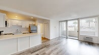 Located at 1840 Winona Blvd in the desirable Los Feliz neighborhood of Los Angeles, this one-bedroom, one-bathroom residence offers a well-designed layout with modern finishes throughout. Light wood-style flooring runs continuously across the entire unit, creating a clean, cohesive aesthetic.

The open-concept living and kitchen area serves as the heart of the home. The kitchen is outfitted with white shaker cabinetry, a subway tile backsplash, quartz countertops, a breakfast bar peninsula, and a full suite of stainless steel appliances including a refrigerator, electric range, microwave, and dishwasher. The living area flows naturally toward a wall of floor-to-ceiling sliding glass doors fitted with vertical blinds, opening onto a private balcony with views of surrounding rooftops and palm trees.

The bedroom is a well-proportioned, quiet retreat featuring crown molding, a large window with vertical blinds for natural light control, and ample closet space — with three closets found throughout the unit. The bathroom is finished with white subway tile surrounding a full soaking tub and shower, a white vanity, and warm vanity lighting. The unit's bright, neutral palette and thoughtful layout make for a comfortable and functional living space.
