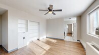 Located at 363 New St in Macon, Georgia, this one-bedroom, one-bathroom unit offers a compact yet well-organized layout across a single floor. The combined living and dining area serves as the heart of the unit, featuring warm wood-look flooring, neutral gray walls, and a ceiling fan with a light fixture that promotes airflow and comfort. A wide window with horizontal blinds fills the space with natural light while framing views of the Macon cityscape. A built-in shelving unit with lower cabinet storage adds functional display and organization space to the living area.

The bedroom continues the same wood-look flooring and neutral palette, with a ceiling fan overhead, windows on two walls for cross-ventilation, and a wall-unit heater. A closet with bifold doors provides dedicated storage.

The kitchen connects seamlessly to the living space and is visible through an open passage, maintaining an open and accessible flow throughout the unit. The bathroom is cleanly appointed with classic white penny tile flooring, a tub-shower combo with white tile surround, a white vanity with black fixtures, and a framed mirror with bar lighting above, creating a crisp, modern aesthetic. Overall, the unit presents a clean, functional design well-suited for efficient urban living.