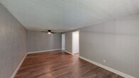 Located at 101 Mosswood Circle in Winter Springs, Florida, this single-story, one-bedroom, one-bathroom residence offers a practical and well-organized layout. Throughout the unit, warm wood-look laminate flooring provides a cohesive aesthetic, complemented by neutral gray walls and crisp white trim.

The combined living and dining area is the heart of the home, featuring a ceiling fan with light fixture, a textured ceiling, and a large window that invites natural light and views of surrounding greenery. A wall-mounted PTAC unit ensures climate control year-round.

The kitchen is efficiently designed with white cabinetry accented by brushed nickel hardware, dark granite-style countertops, and white appliances including an electric range and refrigerator. It opens directly into the main living space for easy flow.

The bedroom is a well-proportioned retreat with its own ceiling fan, a window overlooking the outdoors, and a set of bifold closet doors providing generous storage. Additional closets throughout the unit further enhance storage capacity.

The bathroom is clean and functional, featuring a single-sink vanity with white cabinetry, a wall mirror, and a shower-tub combination. The entire unit reflects a tidy, move-in-ready condition ideal for comfortable single-occupancy living.