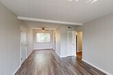 Located at 1100 Indian Circle Dr in Olivette, MO, this one-bedroom, one-bathroom unit offers a well-organized single-floor layout designed for comfortable, efficient living. The open living area features warm wood-style flooring, neutral gray walls, and a ceiling fan, with a large window dressed in vertical blinds that allows ample natural light to fill the space. A hallway connects the main living areas to the private quarters, maintaining a clear and logical flow throughout.

The kitchen is a standout feature, boasting crisp white shaker-style cabinetry, granite-look countertops, a stainless steel refrigerator, a gas range, and a window overlooking greenery — making it both functional and visually appealing. The bathroom is clean and bright, finished in white with a tub-shower combination and a frosted window for natural light.

The bedroom is a comfortable, carpeted retreat with a large window offering outdoor views, neutral tones, and a reach-in closet providing practical storage. A connecting hallway leads seamlessly between rooms. Throughout the unit, consistent flooring choices, clean white trim, and a soft, neutral color palette create a cohesive and inviting atmosphere suited for everyday living.