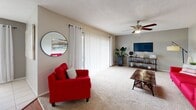 Located at 1475 Woodlake Dr in Lakeland, Florida, this single-floor residence offers a well-organized layout encompassing two bedrooms, one bathroom, an office, and a combined living, dining, and kitchen area connected by a hallway. The living room is generously sized, featuring neutral carpet flooring, a ceiling fan, and a textured ceiling. A large sliding glass door floods the space with natural light and provides an outdoor view, complementing the open, airy feel of the room. The kitchen is functional and efficient, outfitted with rich wood cabinetry, granite-style countertops, tile flooring, and black appliances including a range, dishwasher, and refrigerator. It opens directly into the bright dining area, which benefits from a large window with vertical blinds and is finished with the same light tile flooring. The spacious primary bedroom features plush carpet, a ceiling fan, and ample room for a king-sized bed. The second bedroom is well-proportioned with matching carpet and a ceiling fan. The full bathroom includes a tiled tub-shower combination, tile flooring, and a vanity with storage. An additional office space rounds out this practical and comfortable Lakeland residence.