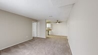 Located in Aurora, Colorado, this single-floor, 2-bedroom, 2-bathroom residence offers a practical and comfortable layout. The open-concept living room is carpeted and bathed in natural light from a sliding glass door that leads to a private balcony, providing pleasant outdoor views. A ceiling fan adds comfort to the space, while textured ceilings and neutral-toned walls create a clean, understated aesthetic throughout.

The galley-style kitchen is efficiently designed with white cabinetry, dark granite-style countertops, a white subway tile backsplash, and tile flooring. It is equipped with stainless steel appliances, including a refrigerator, gas range, microwave, and dishwasher, along with a ceiling-mounted light fixture that brightens the workspace.

The primary bedroom offers a comfortable footprint with plush carpeting, a window allowing natural light, and access to a dedicated closet. The second bedroom similarly features carpet and a closet for storage. Both bedrooms maintain the same neutral color palette found throughout the home. The two bathrooms include a full bath with a tiled tub-shower combo and a vanity bath with a mirror and brushed nickel fixtures, both finished with tile flooring. Two closets provide ample storage across the residence.