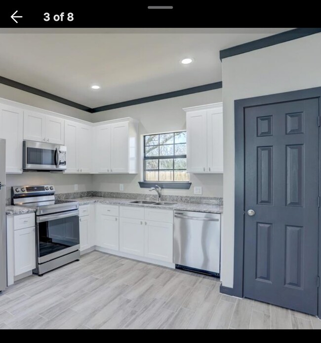 Kitchen with Stainless steel appliances with built in microwave. - 4802 Cruse Rd