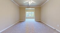 Located at 5227 Walden Way in Flowery Branch, GA, this single-story, 2-bedroom, 1-bathroom home offers a thoughtfully arranged floor plan with comfortable living spaces throughout. Warm, neutral tones and white trim work create a cohesive aesthetic across the entire home.

The kitchen features rich wood cabinetry, granite-look countertops, hardwood-style flooring, and a full suite of black appliances, including a refrigerator, range, dishwasher, and over-the-range microwave. Adjacent to the kitchen, the dining room impresses with vaulted ceilings, crown molding, wainscoting, and an elegant chandelier, adding a refined touch to everyday dining.

The spacious primary bedroom is highlighted by crown molding, a ceiling fan, plush carpeting, and a large window that invites natural light and outdoor views. The second bedroom also features carpet flooring and chair-rail detailing. Both rooms offer a clean, versatile canvas.

The full bathroom includes a tub/shower combination, a wood-vanity with sink, and hardwood-style flooring. A dedicated laundry room with washer/dryer hookups adds everyday convenience. The walk-in closet provides generous storage with built-in wire shelving. Throughout the home, consistent finishes and thoughtful details reflect a well-maintained and move-in ready residence.