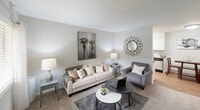 Located at 200 Barnes St in Carrboro, NC, this one-bedroom, one-bathroom residence offers a thoughtfully arranged single-floor layout that makes efficient use of its compact footprint. The living room is bright and welcoming, featuring carpet flooring, a large front-facing window with blinds that invites natural light, and neutral gray walls that create a clean, versatile backdrop. The space comfortably accommodates a seating area, making it ideal for both relaxing and working from home. The kitchen is designed for practicality, featuring white cabinetry, dark countertops, and hardwood-style flooring. It is equipped with black and stainless steel appliances, including a refrigerator, electric range, and over-the-range microwave, all arranged in an efficient galley-style configuration. The bedroom is carpeted and serene, with a textured ceiling, a window allowing soft natural light, and a walk-in closet providing ample storage. The neutral color palette carries throughout, lending a calm and cohesive feel to the room. The bathroom includes a full tub-shower combo with a curtain surround and chrome fixtures, finished in clean white tones. Overall, this residence offers a practical and comfortable living environment well-suited for those seeking a streamlined space in the Carrboro community.