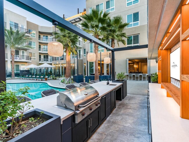 Modera Pomona features a grilling area near the pool, perfect for outdoor meals and relaxation. - Modera Pomona