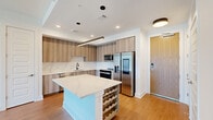 This contemporary 770 square foot apartment in Atlanta, Georgia, offers a harmonious blend of style and functionality. The open-concept floor plan creates a seamless flow between the living areas, maximizing the use of space. The gourmet kitchen is a standout feature, boasting sleek wood-grain cabinetry, stainless steel appliances, and a generous island with built-in wine storage, perfect for both cooking and entertaining.

Floor-to-ceiling windows dominate the living room and bedroom, flooding the space with natural light and providing breathtaking views of the Atlanta skyline. The 130 square foot primary bedroom offers ample space and is complemented by a well-appointed bathroom and a practical closet area with built-in shelving and hanging space.

Throughout the apartment, warm wood-tone flooring contrasts beautifully with the crisp white walls, creating a modern yet inviting atmosphere. Recessed lighting and a sleek ceiling fan add both functionality and style. The bathroom continues the contemporary theme with clean lines and minimalist fixtures.

This efficient single-floor layout makes excellent use of its 770 square feet, providing comfortable living spaces without sacrificing style or amenities. Located at 10 Tower Rd NW in Atlanta, this apartment offers urban living at its finest, combining a prime location with thoughtful design and impressive city views.