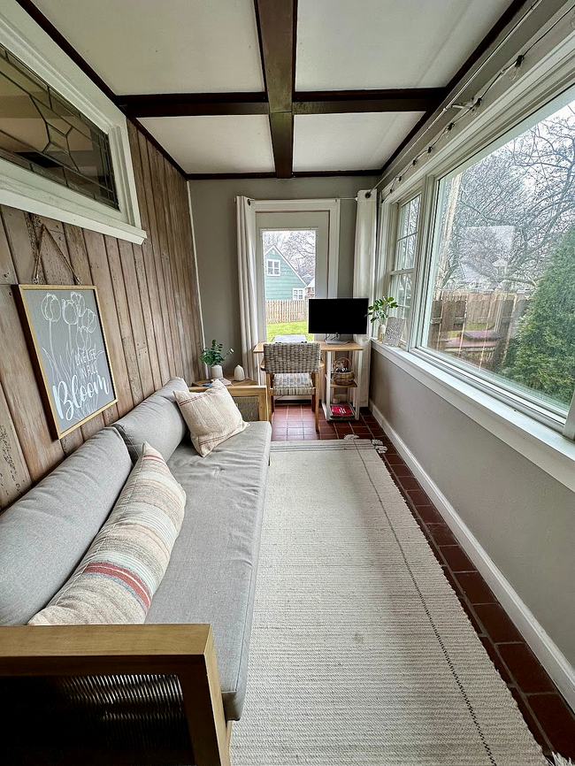 3-season porch off the main living space with windows throughout and door leading to large backyard - 872 N Winton Rd