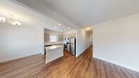 Located on Weaver Ave NE in Leeds, Alabama, this single-story home offers a clean, modern aesthetic defined by neutral tones, warm hardwood-style flooring, and crisp white trim throughout. The open-concept layout creates a seamless flow between the main living areas, making the space feel connected and functional.

The kitchen serves as a central highlight, equipped with stainless steel appliances including a refrigerator, range, microwave, and dishwasher. Gray shaker-style cabinetry pairs with light granite countertops and a subway tile backsplash, while recessed lighting enhances the workspace. A kitchen island provides additional counter space, and a window above the sink brings in natural light. The kitchen opens directly to the dining and living areas, the latter featuring a ceiling fan and access to a garage.

The bedrooms are bright and well-proportioned, each finished with the same hardwood-style flooring and neutral walls. Windows with blinds allow natural light while maintaining privacy. The bathrooms maintain a consistent design language, featuring gray vanity cabinetry, white fixtures, and the same durable flooring. Panel-style doors with matte black hardware add a contemporary touch throughout the home.