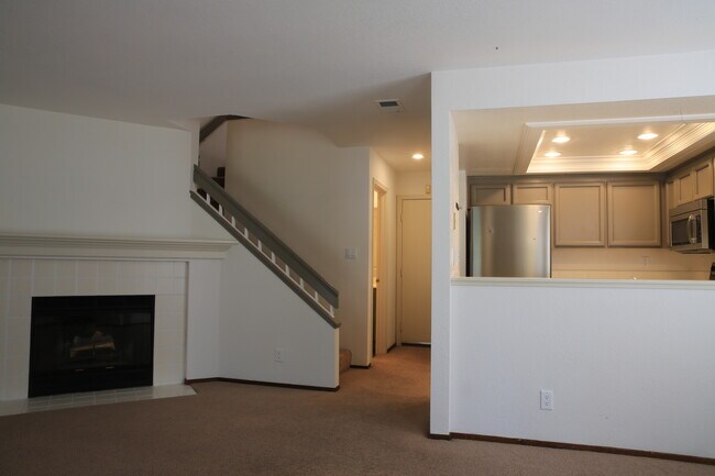 fireplace/stairs/kitchen - 7408 Oxford Cir