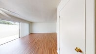 This 860 square foot apartment offers a practical and contemporary living space. The unit features two bedrooms, including a primary bedroom of 160 square feet, and one full bathroom. The open-concept living area combines the kitchen and living room, creating a spacious feel. The kitchen is equipped with wooden cabinetry, white appliances, and ample counter space. Throughout the apartment, you'll find a mix of warm wood flooring and plush carpeting in the bedrooms, adding comfort and style. The bathroom boasts clean, white tiling and a bathtub-shower combination. A notable feature is the in-unit laundry room, complete with shelving for added convenience. Large windows in the bedrooms and living area allow for plenty of natural light, while ceiling fans help maintain a comfortable temperature. The apartment also includes closet space in the bedrooms and a separate storage closet, ensuring ample storage options. The neutral color palette throughout provides a blank canvas for personal decorating styles.