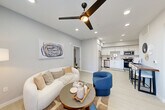 Located at 1349 Blossom Ave in Suisun City, CA, this well-designed 2-bedroom, 2-bathroom single-story home offers a clean, modern aesthetic throughout. The open-concept layout seamlessly connects the living room, dining area, and kitchen, creating a bright and cohesive gathering space. The living room features recessed lighting, a sleek ceiling fan, light luxury vinyl plank flooring, and ample natural light through large windows with blinds. The kitchen is outfitted with white shaker cabinetry, light countertops, stainless steel appliances including a refrigerator, gas range, microwave, and dishwasher, all complemented by recessed lighting overhead. Both bedrooms are carpeted and feature ceiling fans, soft neutral walls, and generous closet space — including a walk-in closet with multi-rod shelving systems. The primary bedroom connects directly to its own bathroom. Both bathrooms are finished with white vanities, large mirrors, and tub-shower combinations with light tile flooring. Additional spaces include an entrance foyer, a hallway, a dedicated laundry area, and a utility room, rounding out the functional layout of this thoughtfully appointed home.
