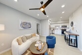 Located at 1349 Blossom Ave in Suisun City, CA, this well-designed 2-bedroom, 2-bathroom single-story home offers a clean, modern aesthetic throughout. The open-concept layout seamlessly connects the living room, dining area, and kitchen, creating a bright and cohesive gathering space. The living room features recessed lighting, a sleek ceiling fan, light luxury vinyl plank flooring, and ample natural light through large windows with blinds. The kitchen is outfitted with white shaker cabinetry, light countertops, stainless steel appliances including a refrigerator, gas range, microwave, and dishwasher, all complemented by recessed lighting overhead. Both bedrooms are carpeted and feature ceiling fans, soft neutral walls, and generous closet space — including a walk-in closet with multi-rod shelving systems. The primary bedroom connects directly to its own bathroom. Both bathrooms are finished with white vanities, large mirrors, and tub-shower combinations with light tile flooring. Additional spaces include an entrance foyer, a hallway, a dedicated laundry area, and a utility room, rounding out the functional layout of this thoughtfully appointed home.
