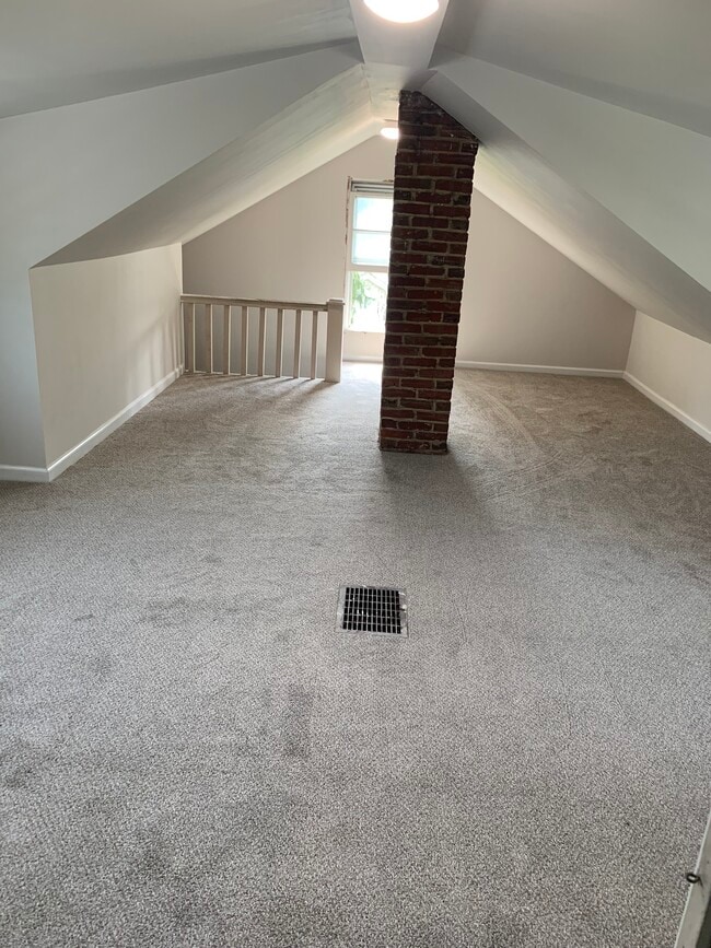 Newly carpeted upstairs bedroom has a walk-in attic for closet and storage. - 126 E. Ormond Ave