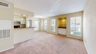 Located at 2200 Montgomery Park Blvd in Conroe, TX, this single-story residence offers two bedrooms and two bathrooms within a well-organized floor plan. The open living and dining area is bright and welcoming, featuring plush carpeting, multiple windows with blinds that invite natural light, and a built-in shelving nook with cabinet storage — an ideal spot for display or a home office setup. Pendant lighting adds a warm ambiance over the kitchen bar.

The kitchen is equipped with white cabinetry, granite-look countertops, wood-look flooring, and black appliances including a full-size refrigerator, providing a clean and functional workspace.

Both bedrooms are carpeted and equipped with ceiling fans and window blinds. The primary bedroom offers a comfortable footprint with direct access to its own bathroom and a dedicated closet. The second bedroom also features a ceiling fan, a sliding glass door for natural light, and its own closet access.

Each bathroom features wood-look flooring, a granite-topped vanity with white cabinetry, a wall mirror, and a tub/shower combination with tiled surround. Both closets include wire shelving systems, maximizing storage efficiency throughout the home.