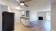 Located at 14304 E Tennessee Ave in Aurora, CO, this single-floor, 2-bedroom, 3-bathroom residence offers a thoughtfully designed layout with modern updates throughout. The interior is finished with warm-toned luxury vinyl plank flooring, neutral gray walls, crisp white baseboards, and textured ceilings that lend a cohesive, contemporary feel to each room.

The open living room serves as the heart of the home, highlighted by a classic black-framed fireplace and a sliding glass door that opens to a private patio, filling the space with natural light and outdoor views. The kitchen features stainless steel appliances, granite-style countertops, white cabinetry with sleek hardware, and efficient galley-style flow.

The spacious primary bedroom provides a comfortable retreat, while the second bedroom benefits from two windows that invite ample natural light. Both bedrooms include closet storage and continue the consistent flooring and neutral palette found throughout.

The bathrooms are clean and functional, with one featuring a granite-topped vanity with white cabinetry and brushed nickel fixtures, and another offering a full tub-shower combo. A dedicated utility room adds practical storage and functionality. Overall, this residence presents a clean, move-in ready living environment with modern touches throughout.