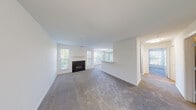 Located at 9204 Appleford Cir in Owings Mills, Maryland, this single-floor residence offers a well-designed, open layout filled with natural light throughout. The spacious living area is anchored by a classic fireplace and flanked by multiple windows that frame lush green outdoor views, creating a bright and inviting atmosphere. Plush wall-to-wall carpeting extends across the living and bedroom areas, adding warmth underfoot.

The kitchen is thoughtfully updated with gray cabinetry, light stone countertops, a white subway tile backsplash, and stainless steel appliances including a gas range and over-the-range microwave. A peninsula counter connects the kitchen to the dining area, which is highlighted by a pendant light and generous window exposure.

The bedroom offers a comfortable, carpeted retreat with ample natural light from dual windows overlooking greenery. A dedicated walk-in closet provides substantial storage. The bathroom features wood-look flooring, a vanity with a stone countertop, and built-in wire shelving for added organization.

A dedicated laundry area with a full-size washer and dryer adds everyday convenience. The clean, neutral palette throughout gives the space a fresh, move-in-ready feel ideal for comfortable single-floor living.
