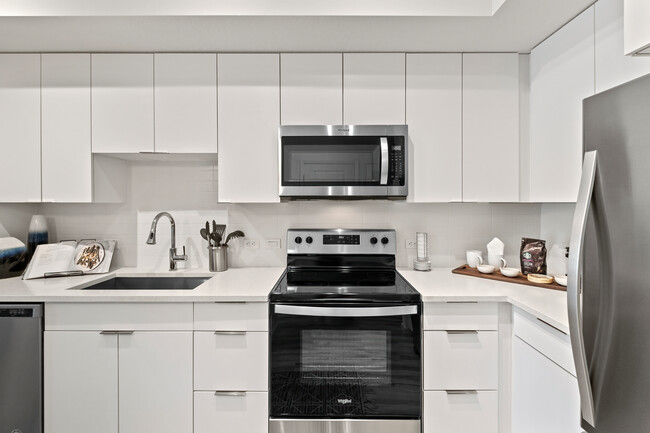 East Phase Kitchen with white cabinetry, white countertops, and stainless steel appliances - Avalon Miramar Park Place