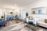 This single-floor residence in Toms River, NJ offers a cohesive and modern interior defined by clean lines, neutral tones, and quality finishes throughout. The entryway welcomes with wood-look plank flooring that extends into the main living areas, setting a warm yet contemporary tone. The spacious living room features recessed lighting, large windows dressed with elegant drapes, and generous proportions ideal for both relaxing and entertaining.

The kitchen is well-equipped with stainless steel appliances, soft-tone cabinetry with brushed hardware, white quartz countertops, and a deep undermount sink. Pendant lighting above the extended island adds both function and style, while wood-look flooring ties the space to the rest of the home.

Multiple bedrooms offer plush carpeting, ceiling fans, and windows that bring in natural light and outdoor views of the surrounding community. Each room provides ample space for furnishings and personal touches.

Two bathrooms serve the residence distinctly—one showcases marble-look tile floors and walls with a glass-enclosed shower, while the other features a tub-shower combination with stone-look tile surround and light wood-tone flooring, both finished with clean white vanities and modern fixtures.