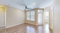 Located at 13555 Cullen Blvd in Houston, TX, this single-story 2-bedroom, 2-bathroom home offers a well-designed layout across a comfortable footprint. The interior features warm wood-look flooring throughout the main living areas and bedrooms, complemented by neutral beige tones that create a bright, cohesive ambiance.

The combined kitchen and living area serves as the heart of the home, with the kitchen showcasing gray cabinetry, granite countertops with a built-in desk or workspace area, open shelving, and black appliances including a full-size refrigerator. The living area benefits from natural light through blinds-fitted windows.

Both bedrooms are well-proportioned and include ceiling fans with lighting and multiple windows that invite natural light. Each bedroom has access to a closet, with the primary bedroom featuring a spacious walk-in closet outfitted with wire shelving and hanging rods on both sides for ample storage.

The primary bathroom is a standout, offering a double-sink vanity with granite countertops and dark cabinetry, a glass-enclosed walk-in shower, tile flooring, and Hollywood-style lighting above the mirrors.

A dedicated laundry room houses a full-size side-by-side washer and dryer. The home's clean, modern finishes and functional layout make it a practical and comfortable residence in Houston.