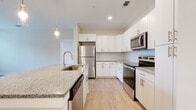 Located at 3506 Buster Lane in Indian Land, South Carolina, this single-floor residence offers a thoughtfully designed layout with modern finishes throughout. The kitchen is a standout feature, showcasing crisp white cabinetry, granite countertops, a classic subway tile backsplash, and a full suite of stainless steel appliances including a refrigerator, range, microwave, and dishwasher. A central island with an integrated sink and pendant lighting adds both functionality and style, while light wood-look flooring ties the space together seamlessly.

The open living area is bright and welcoming, featuring light hardwood-style flooring, a ceiling fan, and large windows that invite natural light and views of the surrounding greenery. A door provides convenient direct outdoor access from the living space.

The bedrooms are carpeted for comfort, each equipped with ceiling fans and generously sized windows fitted with blinds, offering a calm and restful atmosphere. The bathrooms are cleanly finished with white tiled tub-shower combinations, wood-look flooring, and vanities topped with granite countertops and white cabinetry, maintaining a consistent and cohesive aesthetic throughout the home.