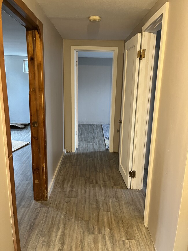 Hallway leading to bathroom and two rooms. - 4017 N Maple St