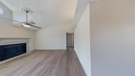 This 800 square foot apartment in Carrollton, TX offers a well-designed living space with two bedrooms and one bathroom. The single-story layout maximizes efficiency, with the primary bedroom spanning a comfortable 140 square feet. The modern kitchen boasts sleek white cabinets, granite countertops, and updated appliances, including a built-in microwave. The living area is a highlight, featuring a fireplace and vaulted ceiling with a ceiling fan, creating an open and airy atmosphere. Large windows throughout provide ample natural light, while wood-look flooring in the main living areas and plush carpeting in the bedrooms add warmth and comfort. The bathroom showcases a clean, white design with a shower/tub combination. Additional features include closet space in both bedrooms and a hallway for added storage. The property's location at 1602 E Frankford Road offers convenient access to local amenities. Overall, this apartment combines modern aesthetics with practical living spaces, ideal for those seeking a contemporary home in a prime location.