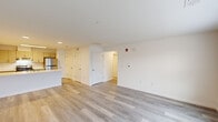 Located at 1000 Sunrise Pl in Burlington, NJ, this single-floor, 3-bedroom, 2-bathroom home offers a clean, modern aesthetic with consistent light-toned luxury vinyl plank flooring throughout. The open-concept living room welcomes abundant natural light through a trio of large windows, creating a bright and airy atmosphere with a clear sightline to the front entry door. The kitchen is a standout feature, boasting a generous peninsula with a light stone-look countertop and integrated sink, complemented by contemporary gray cabinetry, stainless steel appliances including a refrigerator and range, and efficient overhead lighting. A hallway connects the living areas to the three bedrooms, each finished with the same plank flooring and neutral walls. The spacious primary bedroom includes a double-door closet. The two bathrooms are thoughtfully appointed with gray vanities, white countertops, large mirrors, and beige tile flooring. One bathroom features a walk-in shower with neutral tile surround, while the second offers a full tub-shower combination. The home's clean, contemporary design and bright, neutral palette create a fresh and move-in-ready living environment.
