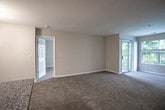 Located at 507 Marcella Rd in Hampton, Virginia, this single-floor residence offers a practical and comfortable layout designed for everyday living. The open living area is finished with plush wall-to-wall carpeting and neutral-toned walls, creating a welcoming atmosphere. A sliding glass door leads directly to a private balcony, bringing in natural light and providing an outdoor retreat. The kitchen is well-appointed with dark wood cabinetry, granite-style countertops, stainless steel appliances including a range, microwave, and dishwasher, and durable wood-look flooring. Conveniently accessible from the kitchen is a dedicated laundry area housing an in-unit washer and dryer. The bedrooms are generously sized, each featuring soft carpeting, neutral walls, and windows that invite natural light. One bedroom includes a walk-in closet, offering ample storage. The bathrooms are clean and functional, each featuring a full soaking tub and shower combination with white tile surround and chrome fixtures. One bathroom features wood-look flooring, while the other offers a classic tiled floor. The overall design is understated and move-in ready, with consistent finishes throughout that lend the home a cohesive, well-maintained character.