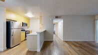 Located in Rosemead, CA, this 2-bedroom, 1-bathroom residence offers a well-organized single-floor layout designed for comfortable everyday living. Wood-look flooring runs throughout the entire space, lending warmth and visual continuity from room to room.

The open-concept living area is bright and welcoming, featuring a sliding glass door that leads to a private balcony overlooking greenery, filling the space with natural light. The kitchen is efficiently laid out in a galley style, equipped with stainless steel appliances including a gas range, microwave, refrigerator, and dishwasher. Light wood cabinetry pairs with granite-style countertops to create a clean, functional workspace.

Both bedrooms are comfortably sized, each featuring mirrored sliding closet doors that enhance the sense of space. The primary bedroom offers a generous footprint with a window that brings in natural light. The second bedroom similarly benefits from a window with outdoor views, connecting it to the surrounding environment.

The bathroom is finished in a crisp, clean white palette, with a tub/shower combination, white cabinetry with chrome hardware, and wood-look flooring that ties back to the rest of the home. A hallway connects the key areas of the residence, providing a logical and efficient flow throughout.