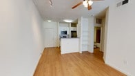 This renovated 1-bedroom, 1-bathroom unit offers a well-designed, single-floor layout that maximizes functionality and comfort. The open-concept living and dining area features warm hardwood-style flooring, a ceiling fan with integrated lighting, and a track lighting system, creating a bright and inviting atmosphere. A window allows natural light to fill the space, enhancing its clean, neutral aesthetic throughout.

The kitchen is thoughtfully positioned with a peninsula counter that separates it from the living area while maintaining an open feel. It is equipped with stainless steel appliances, including a refrigerator, electric range, microwave, and dishwasher, complemented by white cabinetry and dark gray countertops. A deep undermount sink with ample cabinet storage adds to its practicality. Built-in open shelving adjacent to the kitchen provides additional display or storage space.

The bedroom is carpeted for comfort and features a ceiling fan with a window that brings in natural light, offering a peaceful retreat. The full bathroom includes a soaking tub and shower combination with tiled surround, accented by decorative dark tile details, a curved shower rod, and clean, neutral finishes throughout. This unit blends modern updates with a functional layout, making it a comfortable and move-in-ready space.