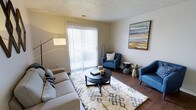 Located at 2223 East 151st Street in Carmel, Indiana, this single-floor residence offers a well-designed layout ideal for comfortable everyday living. The living area serves as the heart of the space, showcasing warm hardwood-style flooring that adds a rich, inviting tone throughout. A large sliding glass door with vertical blinds allows abundant natural light to fill the room while providing direct access to the outdoors, creating a seamless connection between interior and exterior. The textured ceiling adds a classic architectural detail that complements the neutral wall tones. The living space is generously proportioned, accommodating a full seating arrangement with ease, and features a layout that encourages both relaxation and social interaction. Colorful wall art brings a vibrant focal point to the room, adding personality and visual interest. The overall ambiance is bright, clean, and modern, with a neutral palette that provides a versatile backdrop for a variety of interior styles. Situated in the desirable Carmel, Indiana community, this residence benefits from a well-established neighborhood known for its accessibility and quality of life.