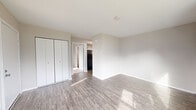This single-floor residence at 71 Hopmeadow St in Weatogue, Connecticut, offers a thoughtfully laid-out living space with clean, updated finishes throughout. The living area features warm hardwood-style flooring and multiple windows that invite abundant natural light, creating a bright and welcoming atmosphere. A sliding glass door opens to an outdoor view of the surrounding greenery, seamlessly connecting the interior to the outdoors.

The kitchen is well-appointed with crisp white shaker-style cabinetry, granite-patterned countertops, and black appliances including a refrigerator and electric range with hood ventilation. The hardwood-style flooring continues into this space, maintaining a cohesive aesthetic throughout the unit.

The bedroom is generously sized, featuring the same hardwood-style flooring, neutral wall tones, and a built-in closet with bifold doors, offering ample storage. The room is filled with natural light, contributing to an airy, comfortable feel.

Additional areas of the home include a carpeted room with baseboard heating, adding warmth and comfort. The neutral color palette used throughout the space provides a versatile canvas, making it easy to personalize. Overall, this residence combines practical design with modern updates in a serene Connecticut setting.