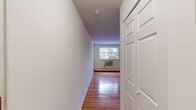 Located at 250 Beverly Blvd in Upper Darby, PA, this single-floor unit offers an efficient and well-organized layout. The spacious living room is the centerpiece of the space, showcasing gleaming hardwood floors that extend throughout and a bright, welcoming ambiance thanks to multiple windows that frame views of surrounding greenery. Baseboard heating and a wall-mounted air conditioning unit ensure year-round comfort. The open sightlines from the living room connect directly to the hallway and kitchen, creating a cohesive flow throughout the unit. The kitchen is neatly appointed with cabinetry, a gas range, and a sink, providing all the essentials within a compact footprint. The bathroom features a vanity with under-sink storage, a mirror cabinet, and clean white tile accents, maintaining a bright and functional aesthetic. Two hallways guide movement through the unit, leading to three closets that provide generous storage options rarely found in similarly sized spaces. The clean white walls throughout contribute to an airy, neutral palette that complements the warmth of the hardwood floors. Overall, this unit delivers practical, comfortable living with a straightforward and efficient design in a convenient Upper Darby location.