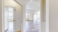 This contemporary apartment at Courts At Huntington Station offers a spacious 1040 square feet of living area on a single floor. The unit boasts two bedrooms, including a generous primary bedroom of 190 square feet, and two full bathrooms. The open-concept design seamlessly integrates the kitchen and living room, creating a fluid and airy atmosphere. 

Throughout the apartment, wood-style flooring adds warmth and durability. The kitchen is a highlight, featuring sleek granite countertops, dark wood cabinetry, and modern stainless steel appliances. A central island provides additional prep space and casual seating.

Large windows in the living area and bedrooms allow ample natural light, enhancing the sense of spaciousness. The bathrooms are fitted with quality fixtures and finishes, including a double vanity in one. 

The apartment's neutral color palette and clean lines contribute to its modern aesthetic, while providing a blank canvas for personalization. A balcony off the living area offers outdoor space and views of the surrounding area. This well-designed apartment combines functionality with contemporary style, ideal for comfortable urban living.
