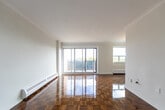 Located at 1704 Victoria Park Ave in Toronto's Victoria Village neighbourhood, this well-appointed 2-bedroom, 1-bathroom unit offers a practical and comfortable layout across a single floor. Gleaming parquet hardwood flooring flows throughout the living, dining, and bedroom areas, lending warmth and character to the space.

The open-concept living and dining room is bright and spacious, featuring baseboard heating and large sliding glass doors that lead directly to a balcony overlooking the surrounding greenery — an ideal spot for relaxing outdoors. A second balcony provides additional outdoor space and natural light.

The galley-style kitchen is thoughtfully designed with white cabinetry, marble-look countertops, a tile backsplash, stainless steel appliances including an electric range and refrigerator, and light tile flooring — combining functionality with a clean, modern aesthetic.

Both bedrooms are well-sized, carrying the same polished parquet flooring. The primary bedroom includes a closet, while the second bedroom benefits from a window with pleasant neighbourhood views. The bathroom features classic white subway tile surrounding a full bathtub with chrome fixtures, offering a crisp, clean finish.

A welcoming entry hallway with tile flooring completes this thoughtfully laid-out home.