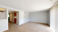 Located at 65 W Summerset Ln in Buffalo, NY, this one-bedroom, one-bathroom residence offers a practical and comfortable single-floor layout. The living room is generously sized, featuring neutral-toned carpet throughout and light gray walls that create a calm, airy atmosphere. A large sliding glass door fitted with vertical blinds fills the space with natural light and provides direct views of the outdoors. The living area flows into a dedicated dining room, which connects to the kitchen. The kitchen features warm wood-toned cabinetry and a functional layout with ample counter space. A hallway connects the main living areas to the private bedroom, which is a comfortable size and includes a closet with a distinctive folding wood-panel door, as well as a window with outdoor views. An additional closet provides further storage options throughout the unit. The bathroom is equipped with a full tub-shower combination with white tile surround, a toilet, a vanity with wood cabinetry, and tile flooring. A utility room and hallway round out the layout, contributing to the efficient and well-organized flow of the home. Overall, the space presents a straightforward, functional design well-suited for everyday living.