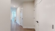 Located at 1500 Bell Road in Nashville, TN, this single-story, 3-bedroom, 2-bathroom home offers a well-designed layout with modern finishes throughout. The open-concept kitchen is a standout feature, showcasing white shaker cabinetry, a white subway tile backsplash, stainless steel appliances, dark granite countertops, and a distinctive curved island with pendant lighting — all set atop light-toned hardwood-style flooring that extends through the main living areas. The living room is bright and airy, featuring a ceiling fan and multiple windows with outdoor views that fill the space with natural light. A central hallway connects the bedrooms, finished with clean white walls, crisp white panel doors, and matte black hardware for a cohesive contemporary look. The bedrooms are carpeted and include ceiling fans, with the secondary bedrooms offering natural light via exterior windows. The primary bedroom is generously sized and connects to a well-appointed en-suite bathroom featuring a double-sink vanity with dark granite countertops, white cabinetry, large-format tile flooring, and a glass-enclosed walk-in shower. The second bathroom also offers a double vanity with matching dark countertops and tile flooring. Two closets provide ample storage throughout the home.