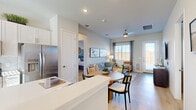 Located in Hutto, Texas, this thoughtfully designed 2-bedroom, 4-bathroom single-story home offers a bright and functional open-concept layout. Light wood-look flooring flows throughout, tying together the kitchen, dining, and living areas into one cohesive space. The kitchen is well-appointed with white shaker cabinetry, a subway tile backsplash, stainless steel appliances including a French door refrigerator and gas range, and a peninsula with bar seating — ideal for casual dining or meal prep. A round dining table sits just beyond the peninsula, leading into the living room, which features a ceiling fan, large windows with natural light, and a glass door opening to an outdoor patio area. The primary bedroom offers a calm, serene atmosphere with a muted blue accent wall, symmetrical windows, and a spacious walk-in closet with built-in shelving and hanging rods. Four well-appointed bathrooms serve the home, with clean, neutral finishes throughout. Two dedicated closets and a hallway round out the floorplan. The home's efficient layout maximizes every square foot while maintaining a comfortable, modern feel suited for everyday living.