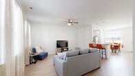 Located at 201 Northwick Blvd in State College, PA, this three-floor home offers a thoughtfully designed layout across three levels, with three bedrooms, four bathrooms, and two closets. The entry level features an open-concept kitchen and living area bathed in natural light from large windows. The kitchen is outfitted with white shaker cabinetry, granite countertops, stainless steel appliances including a dishwasher, range, and microwave, and a peninsula with bar seating. Light wood-style flooring extends seamlessly into the spacious living room, which includes a ceiling fan and ample room for comfortable seating arrangements. A dining area adjacent to the kitchen benefits from a large window overlooking the outdoors. The upper floors house the three bedrooms, each carpeted and featuring ceiling fans. The generously sized primary bedroom includes vaulted ceilings, a dedicated closet, and a walk-in closet with wire shelving. The remaining bedrooms are well-proportioned with natural light and built-in closets. The four bathrooms are clean and modern, with wood-style flooring, white fixtures, and tub-shower combinations. A hallway connects the upper levels, and three staircases provide convenient access throughout the home. The overall aesthetic is clean, bright, and contemporary.