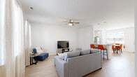 Located at 201 Northwick Blvd in State College, PA, this three-floor home offers a thoughtfully designed layout across three levels, with three bedrooms, four bathrooms, and two closets. The entry level features an open-concept kitchen and living area bathed in natural light from large windows. The kitchen is outfitted with white shaker cabinetry, granite countertops, stainless steel appliances including a dishwasher, range, and microwave, and a peninsula with bar seating. Light wood-style flooring extends seamlessly into the spacious living room, which includes a ceiling fan and ample room for comfortable seating arrangements. A dining area adjacent to the kitchen benefits from a large window overlooking the outdoors. The upper floors house the three bedrooms, each carpeted and featuring ceiling fans. The generously sized primary bedroom includes vaulted ceilings, a dedicated closet, and a walk-in closet with wire shelving. The remaining bedrooms are well-proportioned with natural light and built-in closets. The four bathrooms are clean and modern, with wood-style flooring, white fixtures, and tub-shower combinations. A hallway connects the upper levels, and three staircases provide convenient access throughout the home. The overall aesthetic is clean, bright, and contemporary.