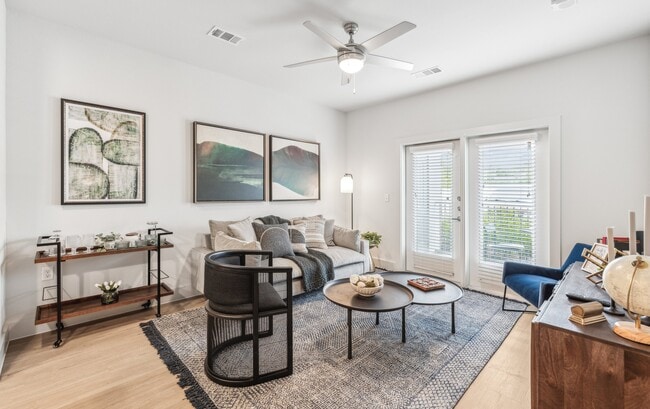 Your Living Room: Hardwood floors and balcony access - Rushcreek at Star Ranch